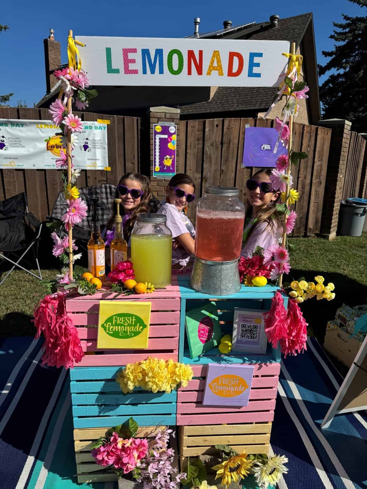 Children at Lemonade Stand Day 2025 selling fresh lemonade with colorful decorations and signage, celebrating community and entrepreneurship.